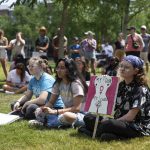 
              Casper Byrd, right, of Bowling Green, sits with friends as they listen to various speakers share their experiences with abortion and women's rights at the BG Freedom Walkers' protest against the overturning of Roe v. Wade and Kentucky's trigger law to ban abortion, at Circus Square Park in Bowling Green, Ky., Saturday, June 25, 2022. (Grace Ramey/Daily News via AP)
            