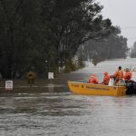 
              A New South Wales State Emergency Service (SES) crew is seen in a rescue boat as roads are submerged under floodwater from the swollen Hawkesbury River in Windsor, northwest of Sydney, Monday, July 4, 2022. (Bianca De Marchi/AAP Image via AP)
            