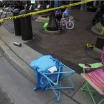 
              Empty chairs, a bicycle and a stroller are seen after a mass shooting at the Highland Park Fourth of July parade in downtown Highland Park, Ill., a Chicago suburb on Monday, July 4, 2022. (AP Photo/Nam Y. Huh)
            