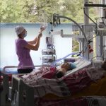 
              A medical worker takes care of people injured during Russian shelling on Thursday in a hospital in Vinnytsia, Ukraine, Friday, July 15, 2022. Russian missiles struck the city of Vinnytsia in central Ukraine on Thursday, killing at least 23 people and injuring more than 100 others, Ukrainian officials said. (AP Photo/Efrem Lukatsky)
            