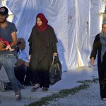 
              Syrian refugee families walk back into a refugee camp after running errands in the town of Bar Elias, in the Bekaa Valley, Lebanon, July 7, 2022. The Lebanese government’s plan to start deporting Syrian refugees has sent waves of fear through vulnerable refugee communities already struggling to survive in their host country. Many refugees say being forced to return to the war shattered country would be a death sentence. (AP Photo/Bilal Hussein)
            