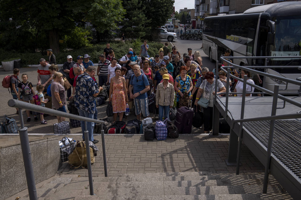 Internally displaced people wait to board a train heading to Dnipro, at the Pokrovsk train station,...