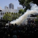 
              Police use teargas as Sri Lankan protesters storm the compound of prime minister Ranil Wickremesinghe 's office, demanding he resign after president Gotabaya Rajapaksa fled the country amid economic crisis in Colombo, Sri Lanka, Wednesday, July 13, 2022. (AP Photo/Rafiq Maqbool)
            