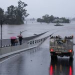 
              An emergency vehicle blocks access to the flooded Windsor Bridge on the outskirts of Sydney, Australia, Monday, July 4, 2022. More than 30,000 residents of Sydney and its surrounds have been told to evacuate or prepare to abandon their homes on Monday as Australia's largest city braces for what could be its worst flooding in 18 months. (AP Photo/Mark Baker)
            
