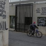 
              A man pedals past vandalized walls of the official residence of the president the day after Ranil Wickremesinghe was elected president in Colombo, Sri Lanka, Thursday, July 21, 2022. Sri Lanka's prime minister was elected president Wednesday by lawmakers who opted for a seasoned, veteran leader to lead the country out of economic collapse, despite widespread public opposition. (AP Photo/Rafiq Maqbool)
            