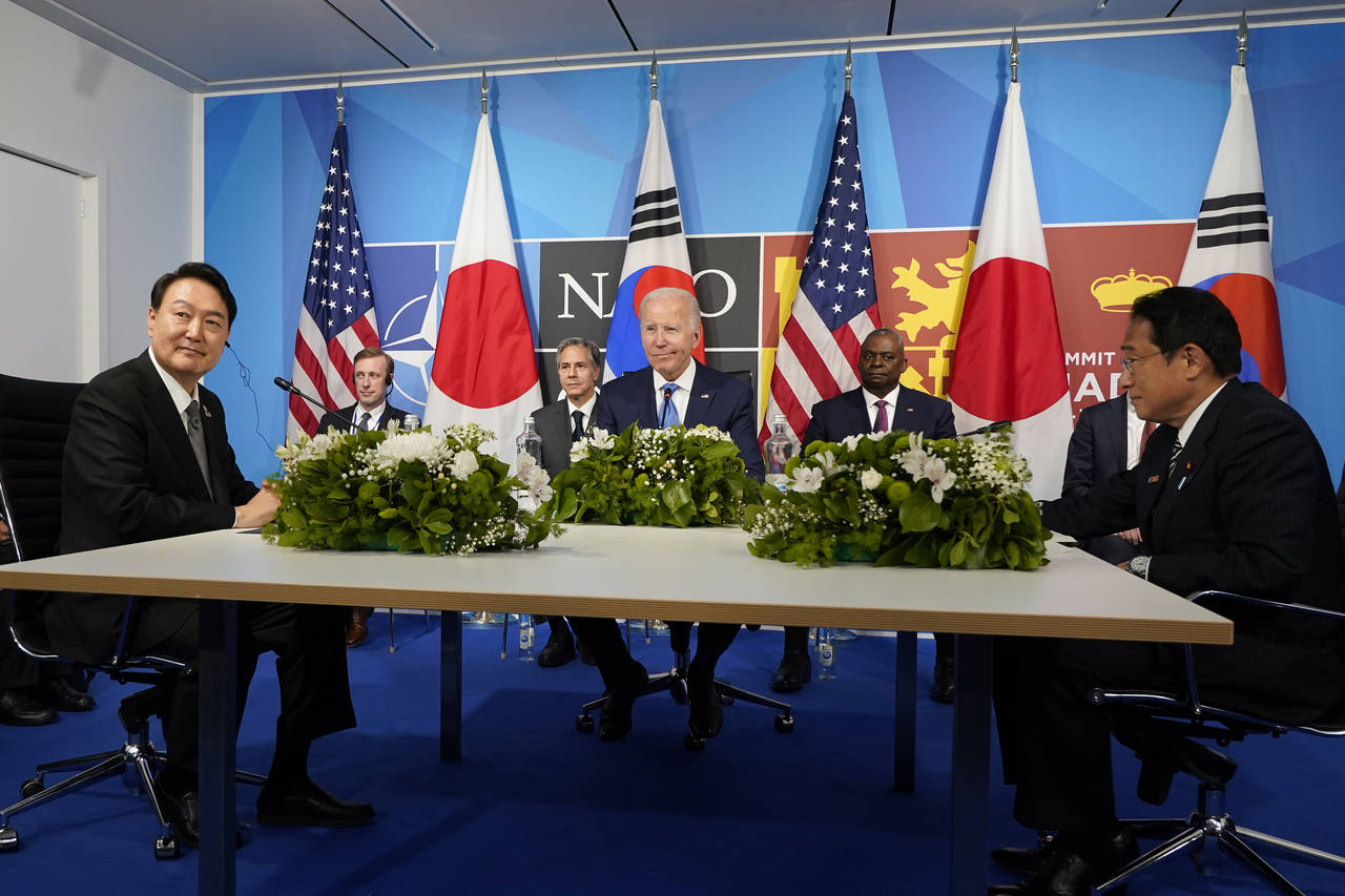 FILE - President Joe Biden, center, meets with South Korea's President Yoon Suk Yeol, left, and Jap...