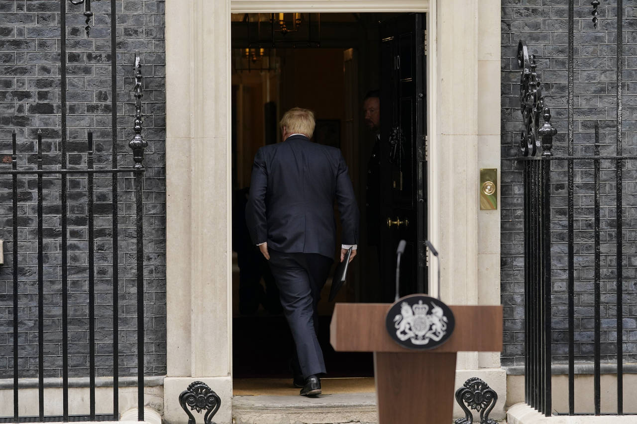 Prime Minister Boris Johnson enters 10 Downing Street, after reading a statement in London, Thursda...
