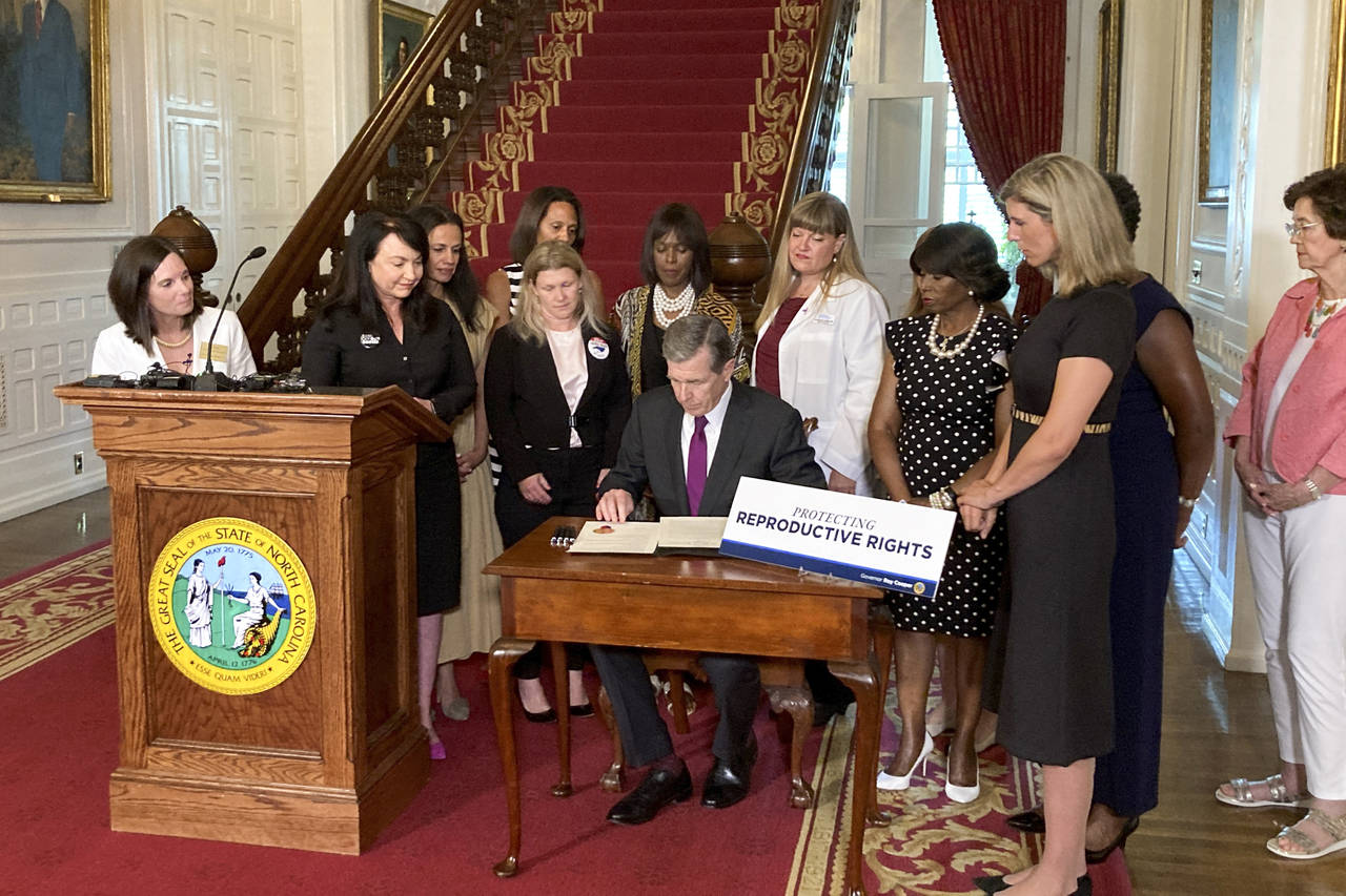 North Carolina Democratic Gov. Roy Cooper signs an executive order designed to protect abortion rig...