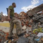 
              A Ukrainian serviceman looks at the rubble of a school that was destroyed some days ago during a missile strike in outskirts of Kharkiv, Ukraine, Tuesday, July, 5, 2022. (AP Photo/Andrii Marienko)
            