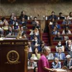 
              French Prime Minister Elisabeth Borne, center right, delivers a speech at the National Assembly, in Paris, France, Wednesday, July 6, 2022. Borne lay out her main priorities at parliament after the government lost its straight majority in the National Assembly in elections last month. (AP Photo/Christophe Ena)
            
