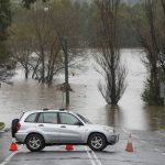 
              A car blocks access to a flooded street at Camden on the outskirts of Sydney, Australia, Monday, July 4, 2022. More than 30,000 residents of Sydney and its surrounds have been told to evacuate or prepare to abandon their homes on Monday as Australia’s largest city braces for what could be its worst flooding in 18 months. (AP Photo/Mark Baker)
            