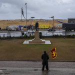 
              A protester stands holding Sri Lankan flag in the compound of presidential secretariat the day after Ranil Wickremesinghe was elected president in Colombo, Sri Lanka, Thursday, July 21, 2022. Sri Lanka's prime minister was elected president Wednesday by lawmakers who opted for a seasoned, veteran leader to lead the country out of economic collapse, despite widespread public opposition.(AP Photo/Rafiq Maqbool)
            