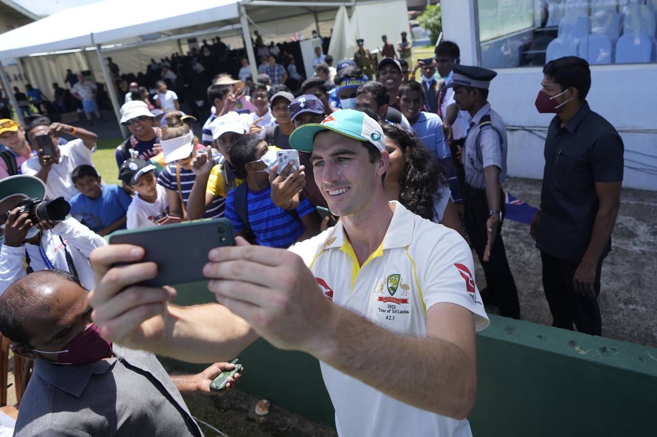 Australia's cricket captain Pat Cummins take selfie photos with fans after defeating Sri Lanka by t...