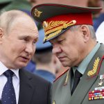 
              FILE - Russian President Vladimir Putin speaks with Russian Defence Minister Sergei Shoigu during a wreath laying ceremony at the Tomb of Unknown Soldier in Moscow, Russia, Wednesday, June 22, 2022, marking the 81st anniversary of the Nazi invasion of the Soviet Union. Defense Minister Sergei Shoigu told President Vladimir Putin  that Russia's troops together with members of a local separatist militia "have established full control over the city of Lysychansk," a ministry statement said Sunday, July 3, 2022. (Mikhail Metzel, Sputnik, Kremlin Pool Photo via AP, File)
            