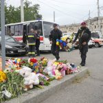 
              Ukrainian servicemen carry flowers to lay at the site of a Russian shelling on Thursday, in Vinnytsia, Ukraine, Friday, July 15, 2022. Russian missiles struck the city of Vinnytsia in central Ukraine on Thursday, killing at least 23 people and injuring more than 100 others, Ukrainian officials said. (AP Photo/Efrem Lukatsky)
            
