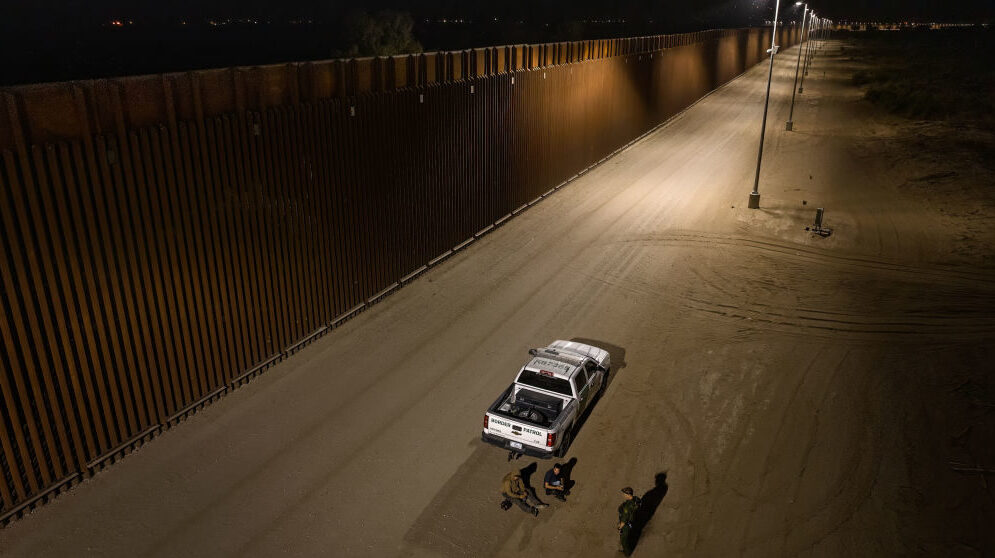Aerial view of two drug smugglers are arrested by U.S. Border Patrol agents after crossing the bord...