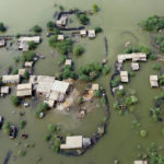 
              Homes are surrounded by floodwaters in Sohbat Pur city, a district of Pakistan's southwestern Baluchistan province, Tuesday, Aug. 30, 2022. Disaster officials say nearly a half million people in Pakistan are crowded into camps after losing their homes in widespread flooding caused by unprecedented monsoon rains in recent weeks. (AP Photo/Zahid Hussain)
            