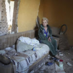 
              Ukrainian woman sits in her flat at a building destroyed during a missile strike in Kharkiv, Ukraine, Thursday, Aug. 18, 2022. (AP Photo/Andrii Marienko)
            