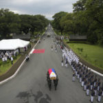 
              Soldiers carry the flag-draped casket of the late former Philippine President Fidel Ramos during his state funeral at the Heroes' Cemetery in Taguig, Philippines on Tuesday Aug. 9, 2022. Ramos was laid to rest in a state funeral Tuesday, hailed as an ex-general, who backed then helped oust a dictatorship and became a defender of democracy and can-do reformist in his poverty-wracked Asian country. (AP Photo/Aaron Favila)
            