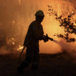 
              A firefighters works to stop a wildfire in Gouveia, in the Serra da Estrela mountain range, in Portugal on Thursday, Aug. 18, 2022. Authorities in Portugal said Thursday they had brought under control a wildfire that for almost two weeks raced through pine forests in the Serra da Estrela national park, but later in the day a new fire started and threatened Gouveia. (AP Photo/Joao Henriques)
            