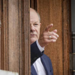 
              Chancellor Olaf Scholz gestures waits for the prime minister of Spain at the closed meeting of the federal cabinet outside Meseberg Palace, Tuesday, Aug.30, 2022. The topics of the closed meeting are the energy crisis and price increases. (Kay Nietfeld/dpa via AP)
            