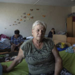 
              Natalia Gymsa, 66, sits on her bed at a center for displaced people near Mykolaiv, Ukraine, Tuesday, Aug. 9, 2022. Natalia's house was destroyed by Russian attacks in the village of Ukrainka, Mykolaiv region. Many people like Natalia are unable to return home because of the continuing fighting. (AP Photo/Evgeniy Maloletka)
            