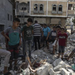 
              Palestinians search through the rubble of a building in which Khaled Mansour, a top Islamic Jihad militant was killed following an Israeli airstrike in Rafah, southern Gaza strip, Sunday, Aug. 7, 2022. An Israeli airstrike killed a senior commander in the Palestinian militant group Islamic Jihad, authorities said Sunday, its second leader to be slain amid an escalating cross-border conflict. (AP Photo/Fatima Shbair)
            