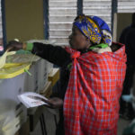 
              People line up to vote at the Moi avenue Primary School in Nairobi, Kenya, Tuesday, Aug. 9, 2022. Polls opened Tuesday in Kenya's unusual presidential election, where a longtime opposition leader who is backed by the outgoing president faces the deputy president who styles himself as the outsider. (AP Photo/Khalil Senosi)
            