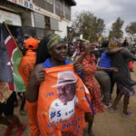 
              Kenyan opposition leader Raila Odinga supporters dance in the Kibera neighborhood of Nairobi, Kenya, Monday, Aug. 15, 2022, as the country continues to wait for the results of the presidential election in which Kenyans chose between Odinga and Deputy President William Ruto to succeed President Uhuru Kenyatta after a decade in power. (AP Photo/Ben Curtis)
            