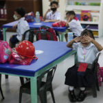
              A girl cries during the opening of classes at the San Juan Elementary School in Pasig, Philippines on Monday, Aug. 22, 2022. Millions of students wearing face masks streamed back to grade and high schools across the Philippines Monday in their first in-person classes after two years of coronavirus lockdowns that are feared to have worsened one of the world's most alarming illiteracy rates among children. (AP Photo/Aaron Favila)
            