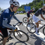 
              Members of the Qiyi bicycle club ride along a rural highway during a group ride through the Baihe River Canyon in the northern outskirts of Beijing, Wednesday, July 13, 2022. Cycling has gained increasing popularity in China as a sport. A coronavirus outbreak that shut down indoor sports facilities in Beijing earlier this year encouraged people to try outdoor sports including cycling, which was only a major tool of transport before 2000. (AP Photo/Mark Schiefelbein)
            