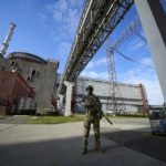 
              FILE - A Russian serviceman guards an area of the Zaporizhzhia Nuclear Power Station in territory under Russian military control, southeastern Ukraine, May 1, 2022. Ukrainians are once again anxious and alarmed about the fate of a nuclear power plant in a land that was home to the world’s worst atomic accident in 1986 at Chernobyl. The Zaporizhzhia nuclear plant, Europe’s largest, has been occupied by Russian forces and continued fighting nearby has heightened fears of a catastrophe that could affect nearby towns in southern Ukraine or beyond. (AP Photo/File)
            