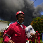 
              Members of the Cuban Red Cross prepare to be transported to the Matanzas Supertanker Base, where firefighters work to quell a blaze which began during a thunderstorm the night before, in Matazanas, Cuba, Saturday, Aug. 6, 2022. The fire at an oil storage facility raged uncontrolled Saturday, where four explosions and flames injured nearly 80 people and left over a dozen firefighters missing, Cuban authorities said. (AP Photo/Ramon Espinosa)
            