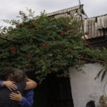 
              Nina Bilyk, right, is embraced by her friend, Olga Gurina, as she mourns the loss of her partner, Ivan Fartukh, at their home Saturday, Aug. 13, 2022, where he was killed in a Russian rocket attack last night in Kramatorsk, Donetsk region, eastern Ukraine. The strike killed three people and wounded 13 others, according to the mayor. The attack came less than a day after 11 other rockets were fired at the city. (AP Photo/David Goldman)
            