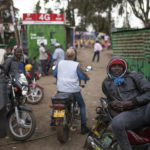 
              Motorcycle drivers wait for customers in the neighborhood of Kibera, in Nairobi, Kenya, Tuesday, Aug. 16, 2022. Kenya is calm a day after Deputy President William Ruto was declared the winner of the narrow presidential election over longtime opposition figure Raila Odinga. (AP Photo/Mosa'ab Elshamy)
            