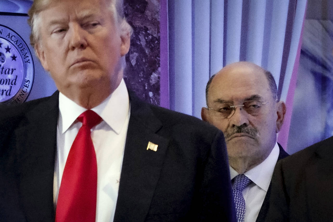 FILE - Allen Weisselberg, right, stands behind then President-elect Donald Trump during a news conf...