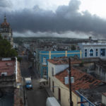 
              Smoke rises from a deadly fire at a large oil storage facility in Matanzas, Cuba, Tuesday, Aug. 9, 2022. The fire was triggered when lighting struck one of the facility’s eight tanks late Friday, Aug. 5th.  (AP Photo/Ismael Francisco)
            