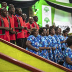 
              A choir performs hymns and prayers while agents and election officials verify the vote-tallying at the Electoral Commission headquarters, in Nairobi, Kenya, Friday, Aug. 12, 2022. Vote-tallying in Kenya's close presidential election isn't moving fast enough, the electoral commission chair said Friday, while parallel counting by local media dramatically slowed amid concerns about censorship or meddling. (AP Photo/Mosa'ab Elshamy)
            