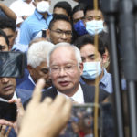 
              Former Malaysian Prime Minister Najib Razak, center, speaks to supporters outside at Court of Appeal in Putrajaya, Malaysia Tuesday, Aug. 23, 2022. Malaysia’s top court has upheld Najib’s conviction and 12-year jail sentence in a graft case linked to the looting of the 1MDB state fund. Najib’s loss in his final appeal means he will have to begin serving his sentence immediately, becoming the first former prime minister to be jailed. (AP Photo)
            