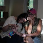 Kirsten Gomez, left, lays her head on her mom, Sandy Laferty's shoulder as they talk about the damage flooding has done to their homes and lives, Tuesday, Aug. 2, 2022, in Hindman, Ky. (AP Photo/Brynn Anderson)