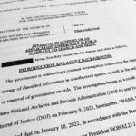 The affidavit by the FBI in support of obtaining a search warrant for former President Donald Trump's Mar-a-Lago estate is photographed Friday, Aug. 26, 2022. U.S. Magistrate Judge Bruce Reinhart ordered the Justice Department to make public a redacted version of the affidavit it relied on when federal agents searched Trump's estate to look for classified documents. (AP Photo/Jon Elswick)