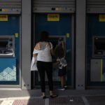 
              A woman and a child use an ATM machine in central Athens, Greece, Friday, Aug. 19, 2022. Saturday's formal end of Greece's close budgetary supervision by European Union creditors closes an unwelcome chapter dating back to the painful bailout years. (AP Photo/Thanassis Stavrakis)
            