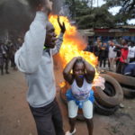 
              Shouting "No Raila No Peace," Kenyan opposition leader Raila Odinga supporters burn tyres in the Kibera neighborhood of Nairobi, Kenya, Monday, Aug. 15, 2022. Kenya’s electoral commission chairman has declared Deputy President William Ruto the winner of the close presidential election over five-time contender Raila Odinga, a triumph for the man who shook up politics by appealing to struggling Kenyans on economic terms and not on traditional ethnic ones. (AP Photo/Ben Curtis)
            