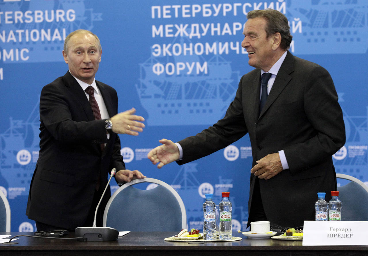 FILE -- Russian President Vladimir Putin, left, and Germany's former Chancellor Gerhard Schroeder a...