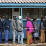 
              People line up to vote at the Kibera Primary School in Nairobi, Kenya, Tuesday, Aug. 9, 2022. Polls opened Tuesday in Kenya's unusual presidential election, where a longtime opposition leader who is backed by the outgoing president faces the deputy president who styles himself as the outsider. (AP Photo/Mosa'ab Elshamy)
            