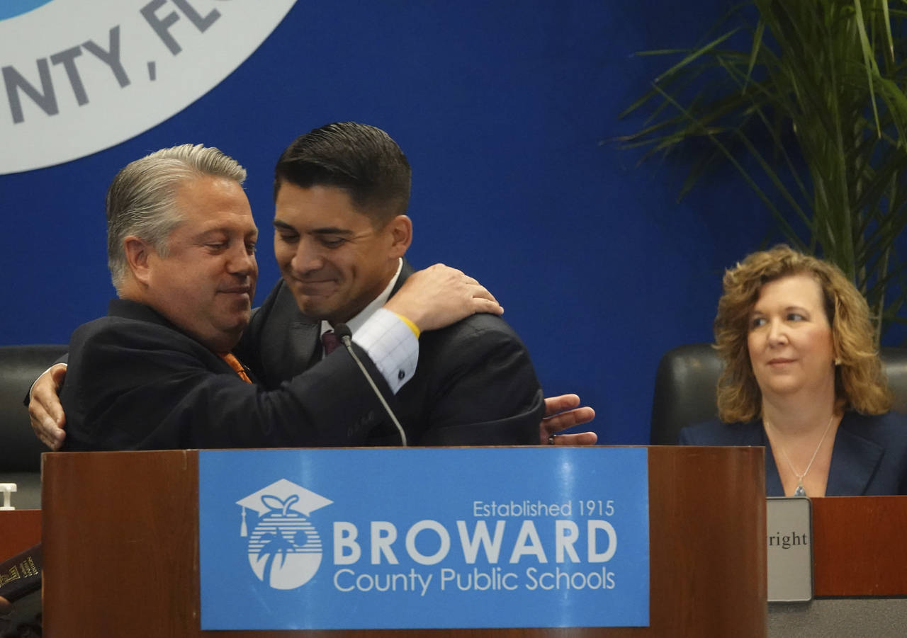 New Broward County School Board member Ryan Reiter, right, is congratulated by Fla., State Rep. Chi...