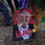 
              An image of former Brazilian President Luiz Inacio Lula da Silva, who is running for reelection, lays on the ground during a campaign rally for his rival, current President Jair Bolsonaro, in Juiz de Fora, Minas Gerais state, Brazil, Tuesday, Aug. 16, 2022. Bolsonaro formally began his campaign for re-election in this town where he was stabbed during his 2018 campaign. General elections are set for Oct. 2. (AP Photo/Silvia Izquierdo)
            