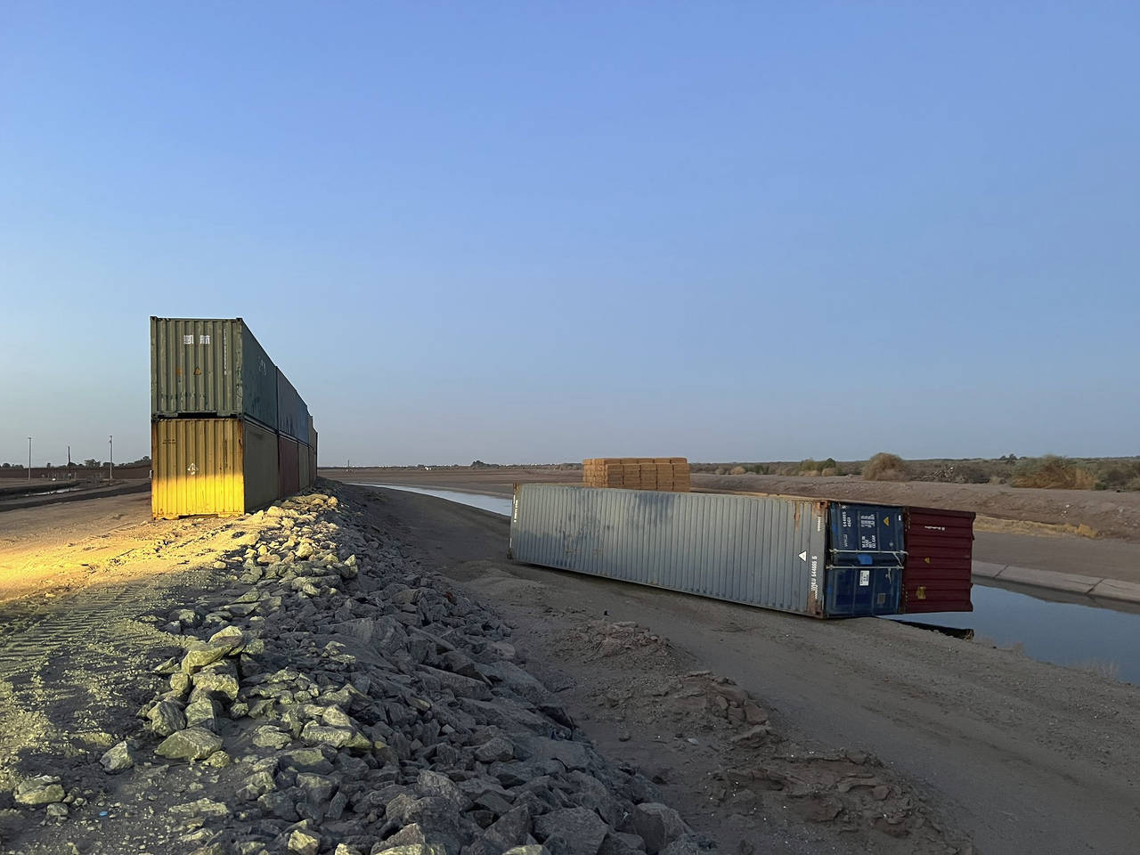 This photo provided of Univision Arizona shows empty shipping containers toppled over Sunday overni...