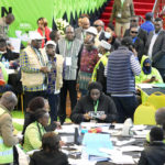 
              The Electoral Commission (IEBC) Chairman, Wafula Chebukati, middle in red shirt, and IEBC commissioners at the National Tallying Centre in Bomas of Kenya, Nairobi, Kenya, Sunday, Aug.1 4, 2022. Kenyans are waiting for the results of a close presidential election in which the turnout was lower than usual. (AP Photo/Sayyid Abdul Azim)
            