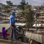 
              A boy looks out over the Kibera area of Nairobi, Kenya, Friday, Aug. 12, 2022. Vote-tallying in Kenya's close presidential election isn't moving fast enough, the electoral commission chair said Friday. (AP Photo/Ben Curtis)
            